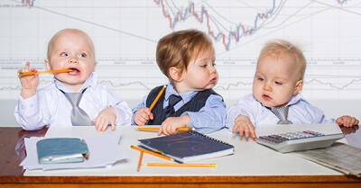 Babies dressed up working in an office